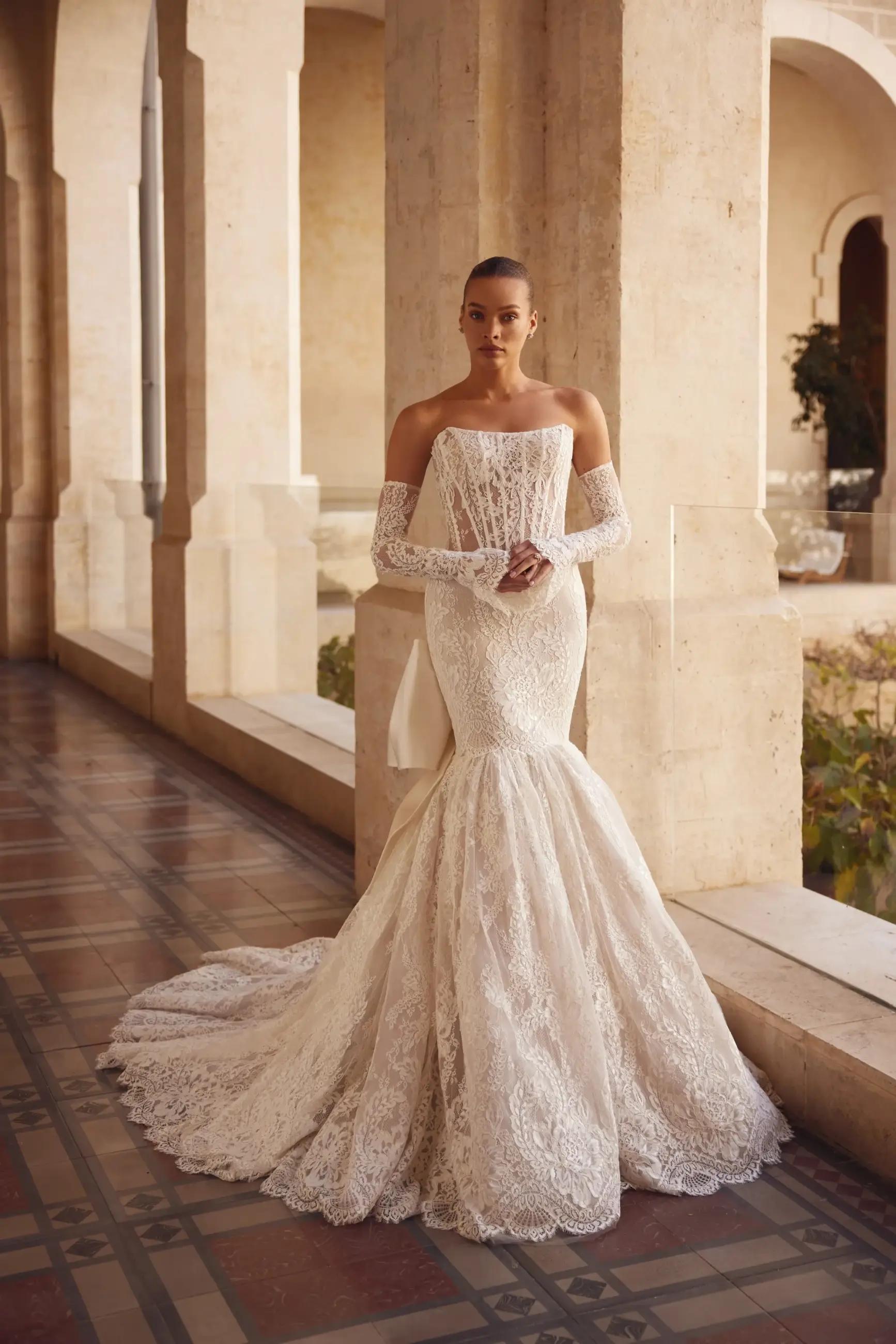 Model wearing a white dress by Pnina Tornai