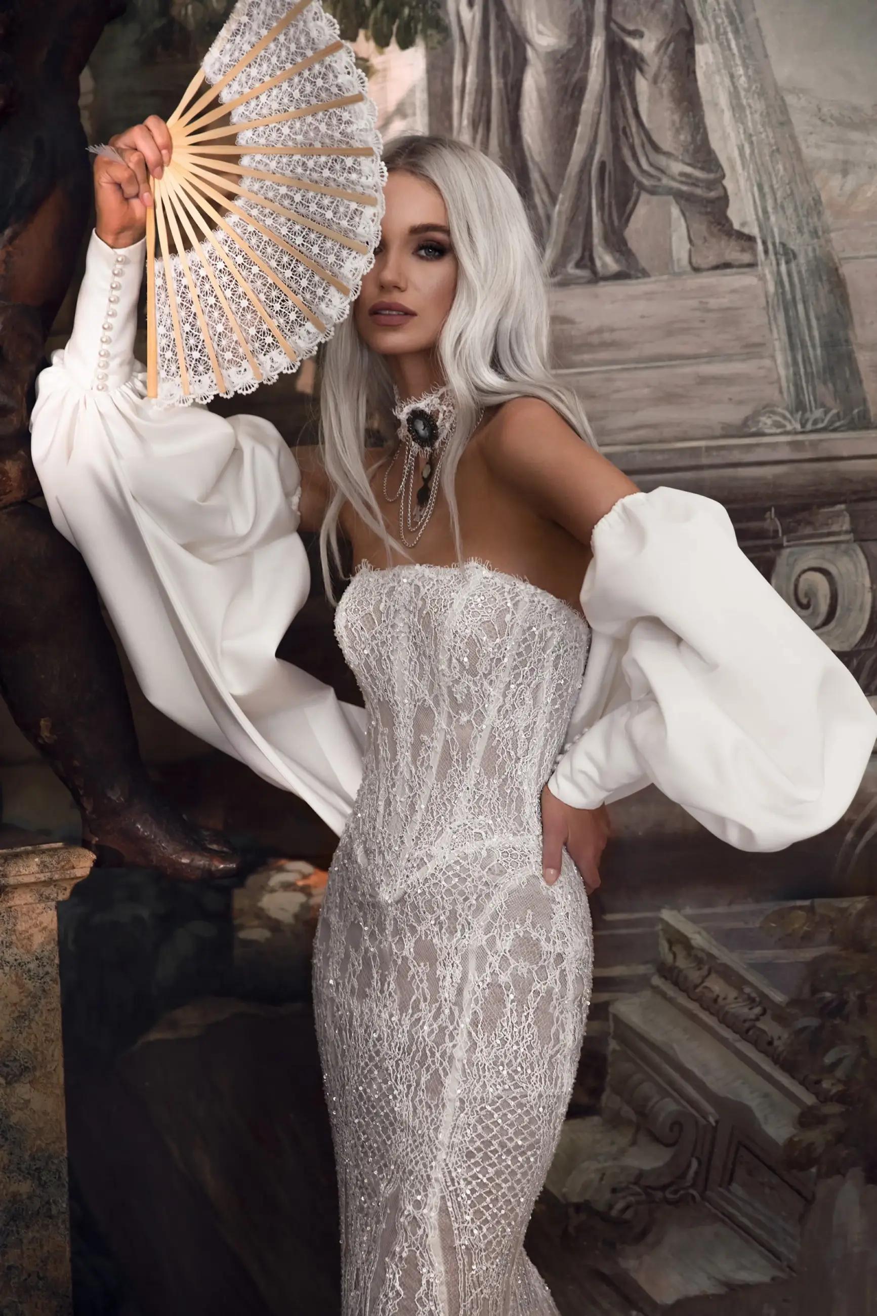Model wearing a white dress by Tom Sebastien