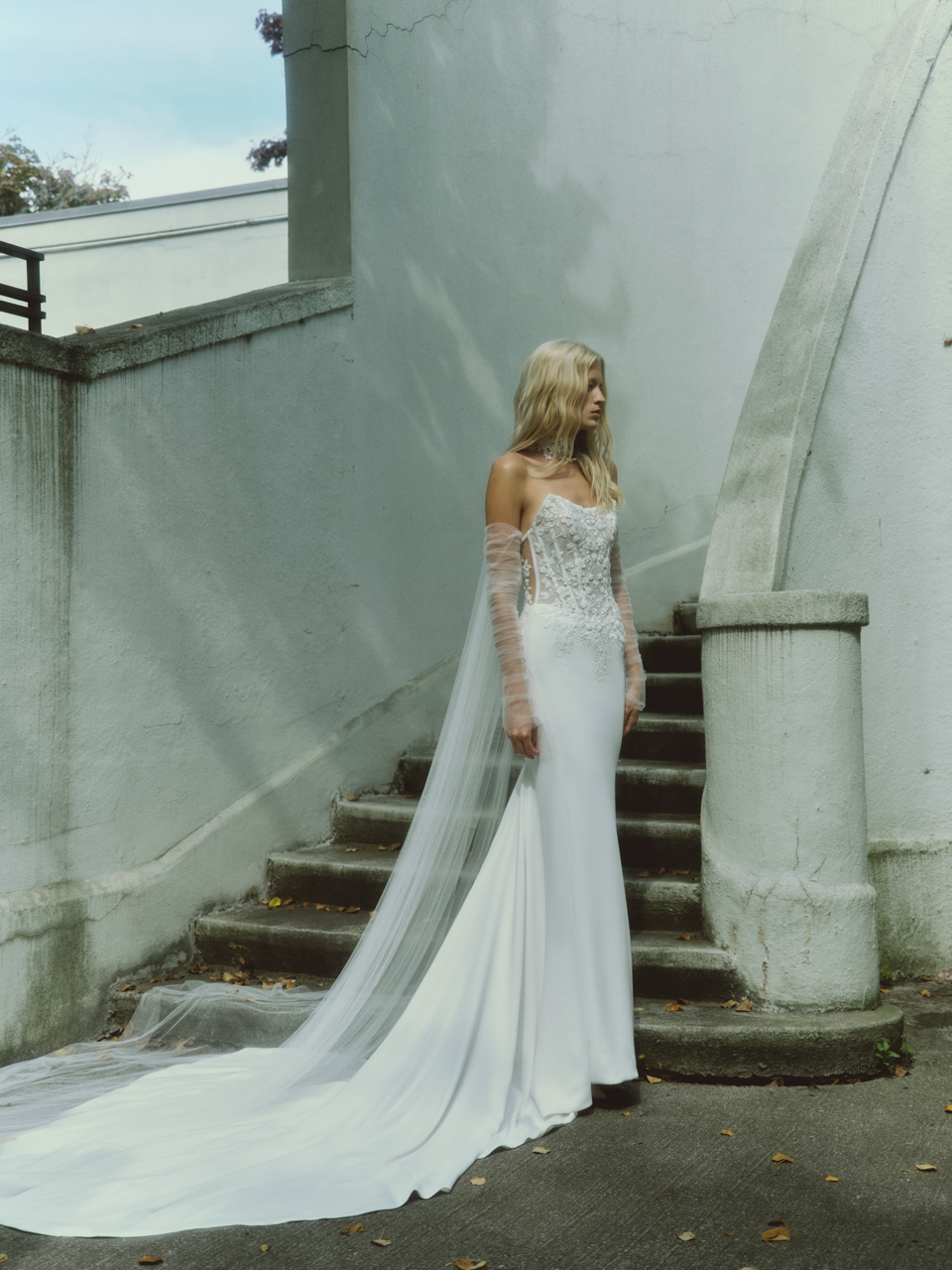 Model wearing a white dress by Rita Vinieris